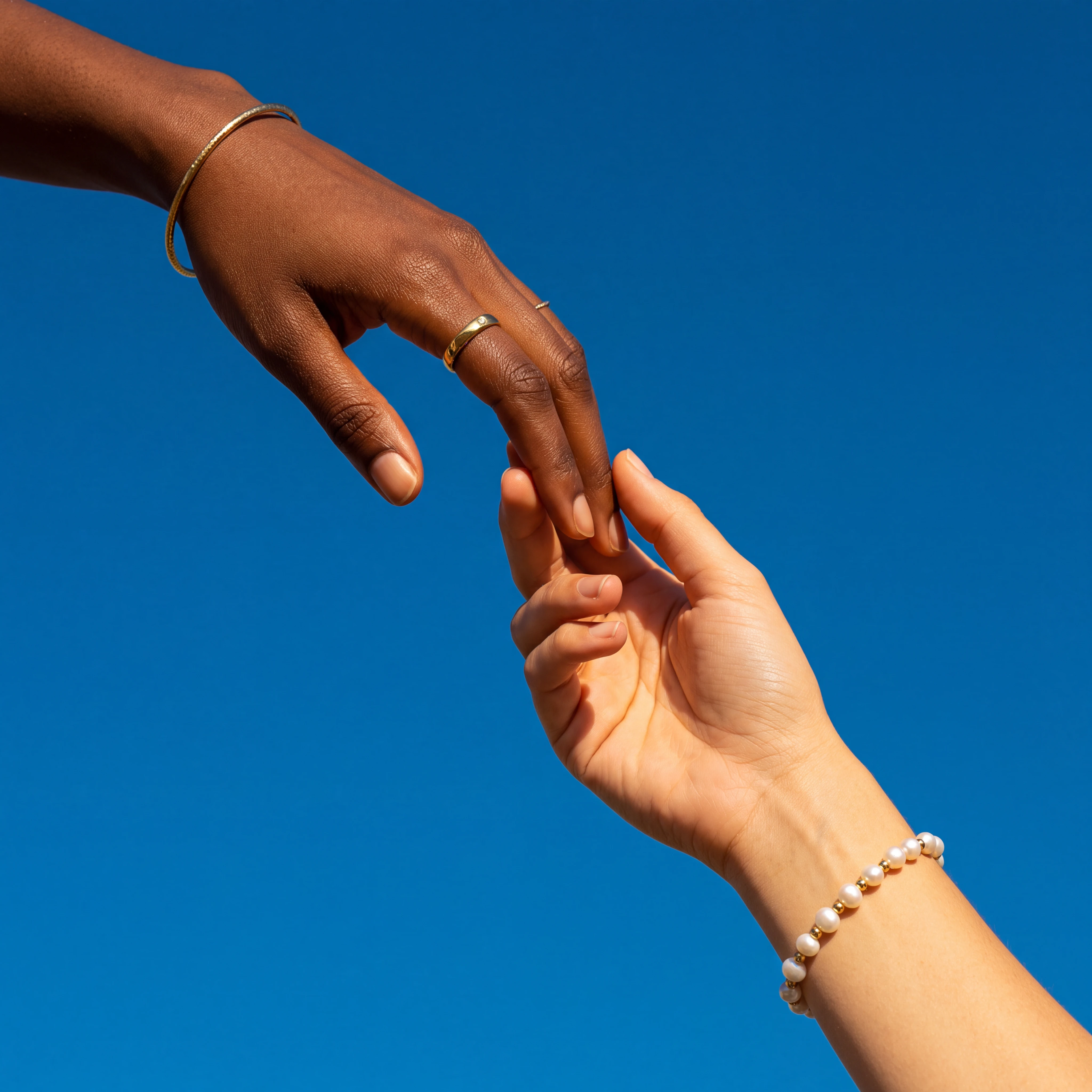 Two hands reaching toward each other against a blue background, symbolizing connection.